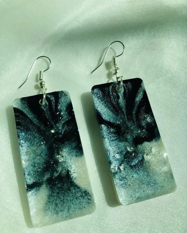 Black and pearl colour resin earrings, featuring a